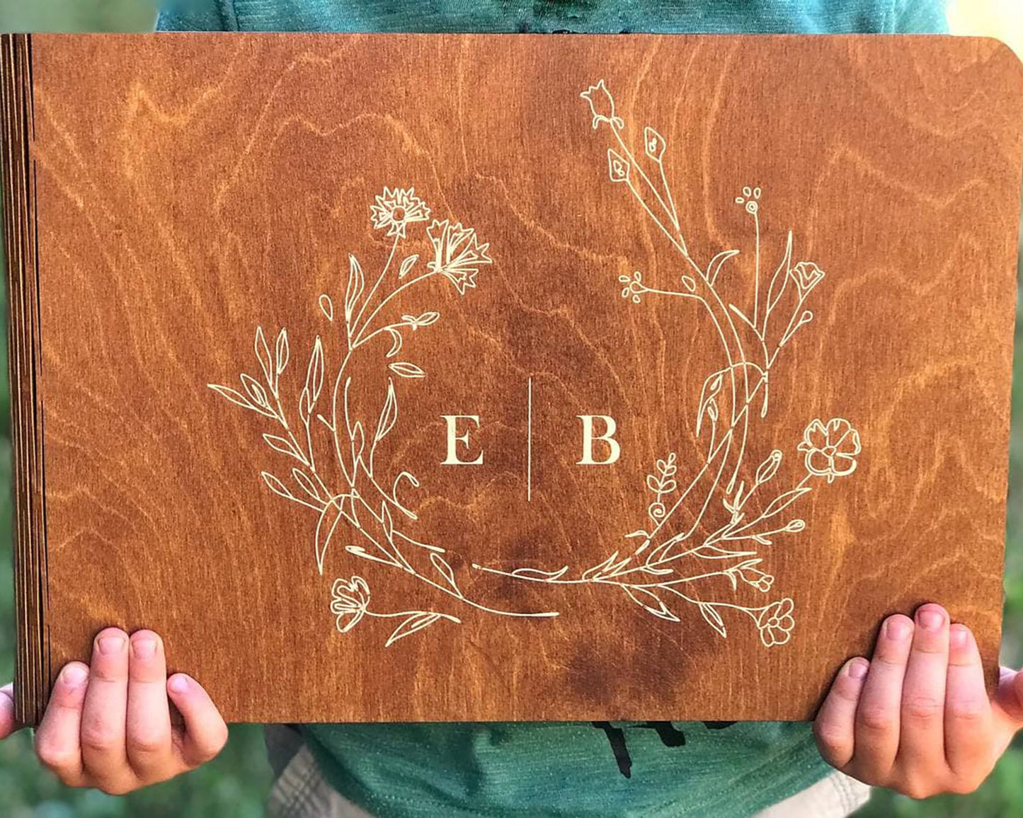 Personalized wooden photo album with engraved names on cover